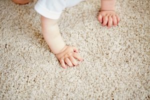 baby crawling on rug