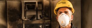 servicemaster technician waring face mask after fire